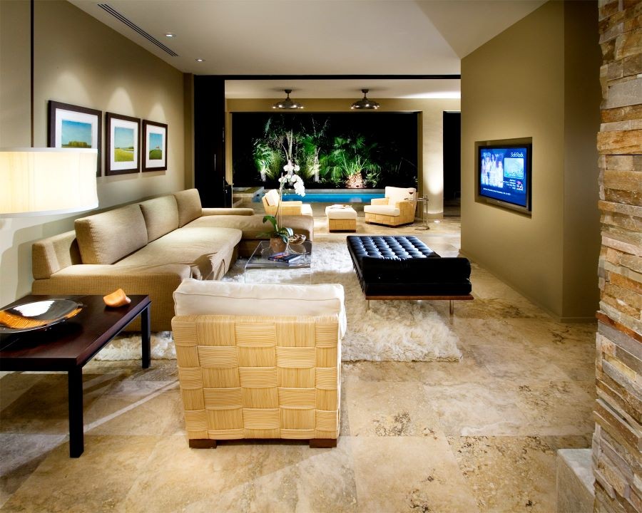 Living area with open-air floor plan overlooking pool and inset TV screen.