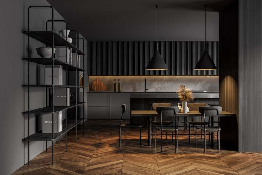 A modern black kitchen enhanced with fancy lighting fixtures.